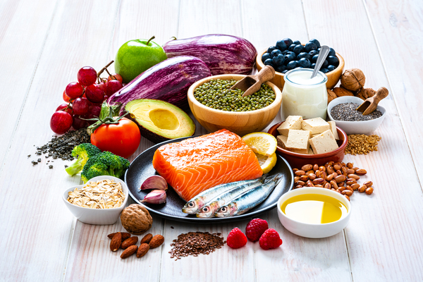 Pile of food on a table. There are representations of every food group.