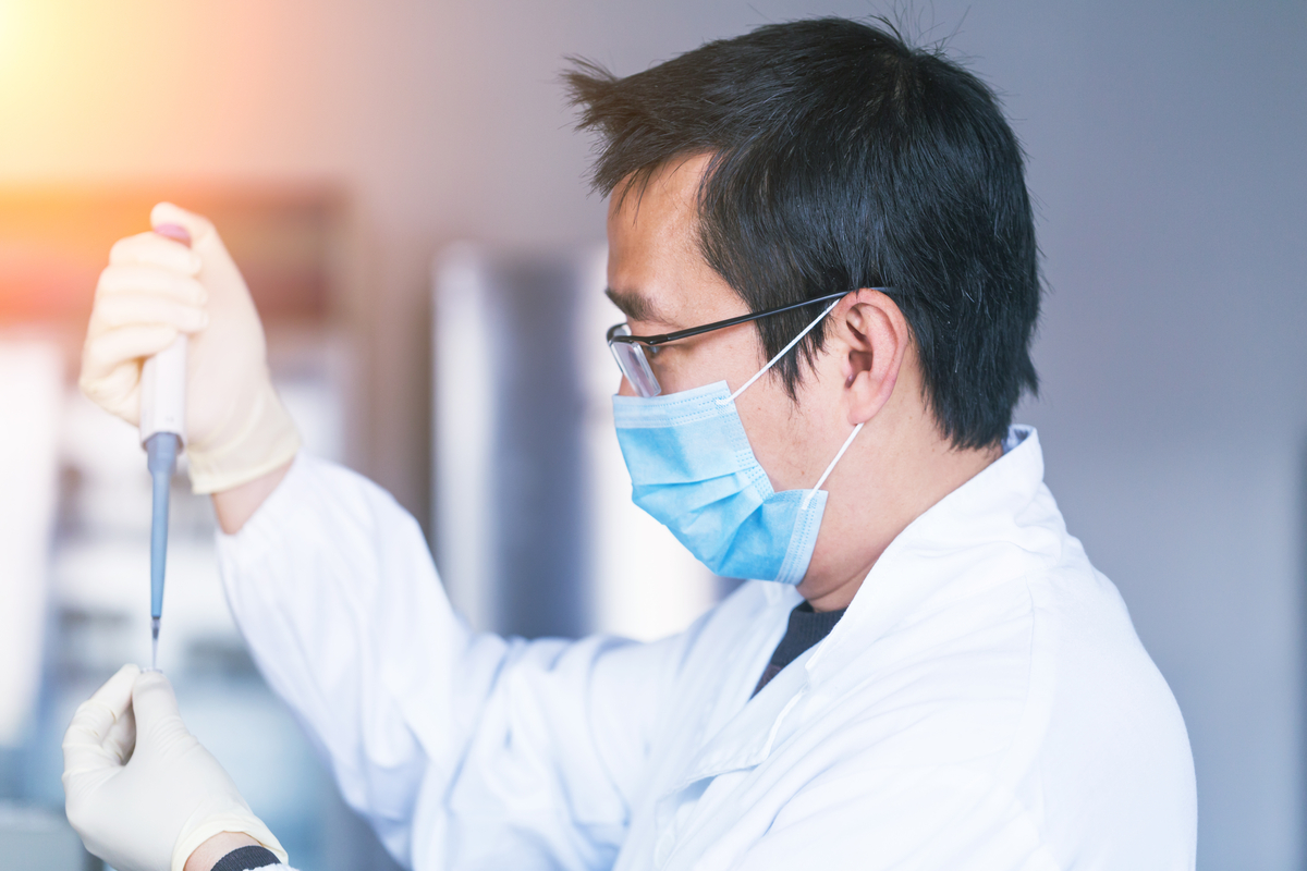 Scientist hovering pipette over vails